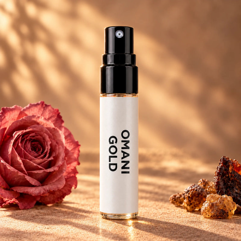 Fragrance Republic Omani Gold 5ml perfume sample spray beside a rose and amber-coloured resin.