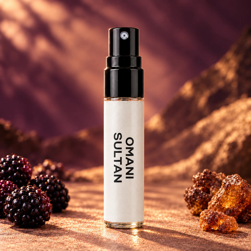 Fragrance Republic Omani Sultan 5ml perfume sample spray beside blackberries and amber-coloured resin.
