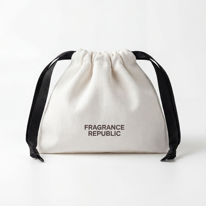 White drawstring fabric bottle bag with black ribbons and printed text on front