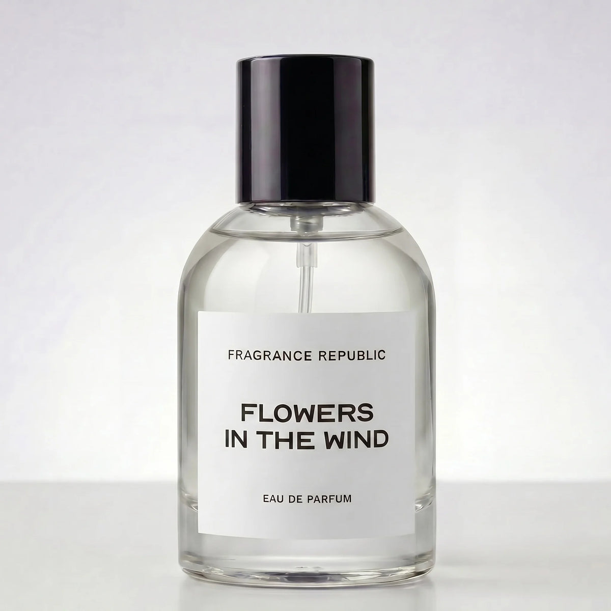 Clear perfume bottle labeled 'Flowers in the Wind' by Fragrance Republic on a white background