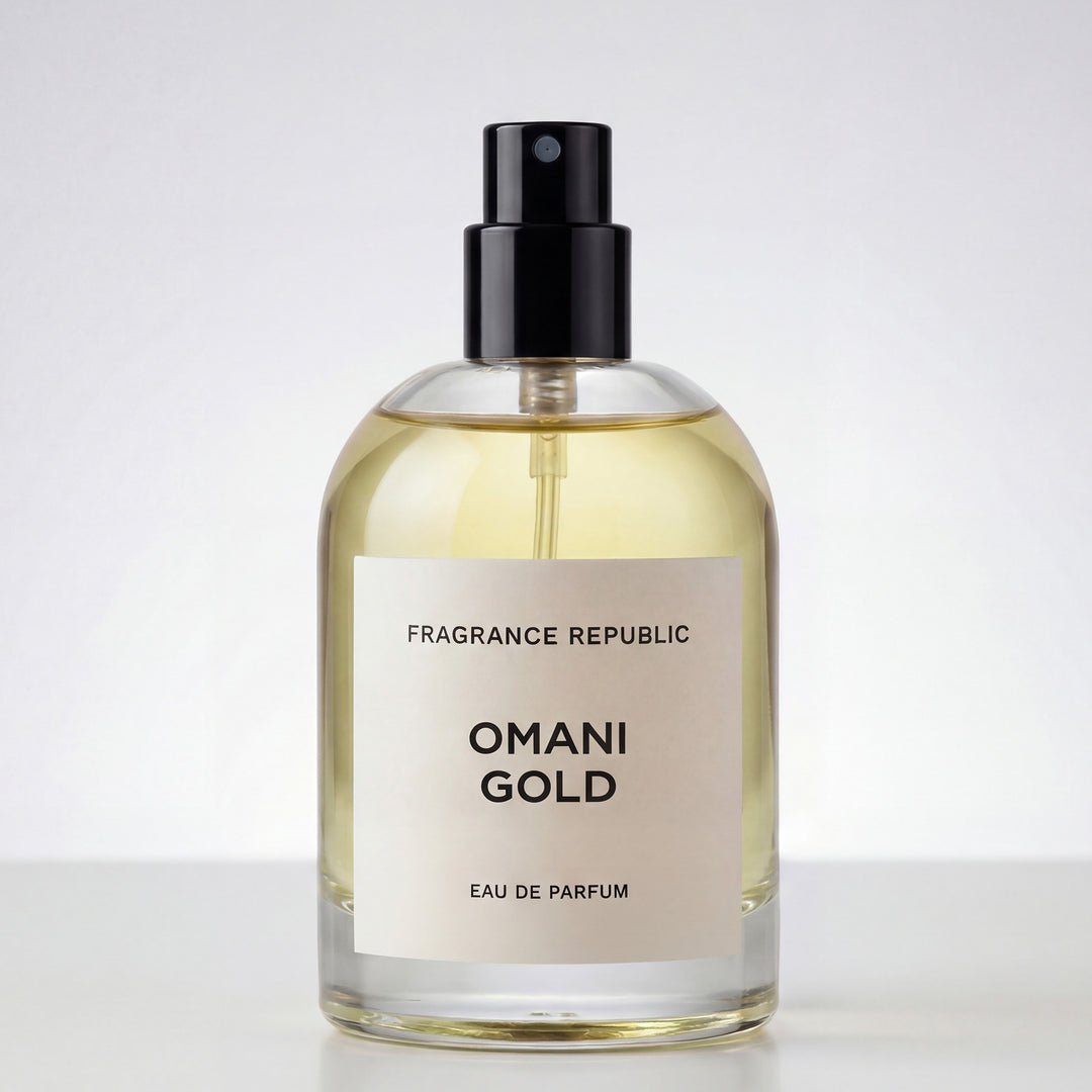 Clear glass bottle of Omani Gold Eau de Parfum with black spray cap on white background