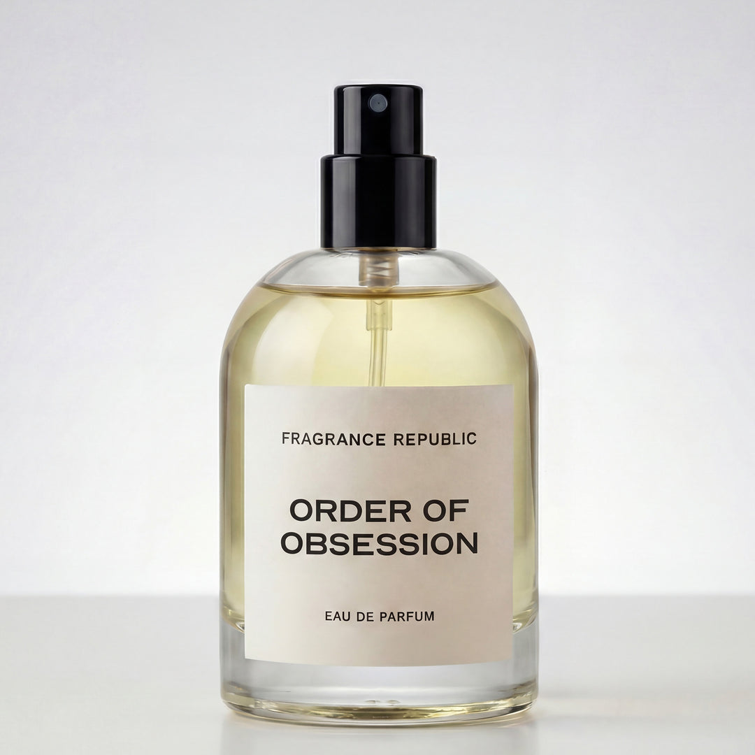 Clear glass bottle of Order of Obsession eau de parfum with black spray cap on white background