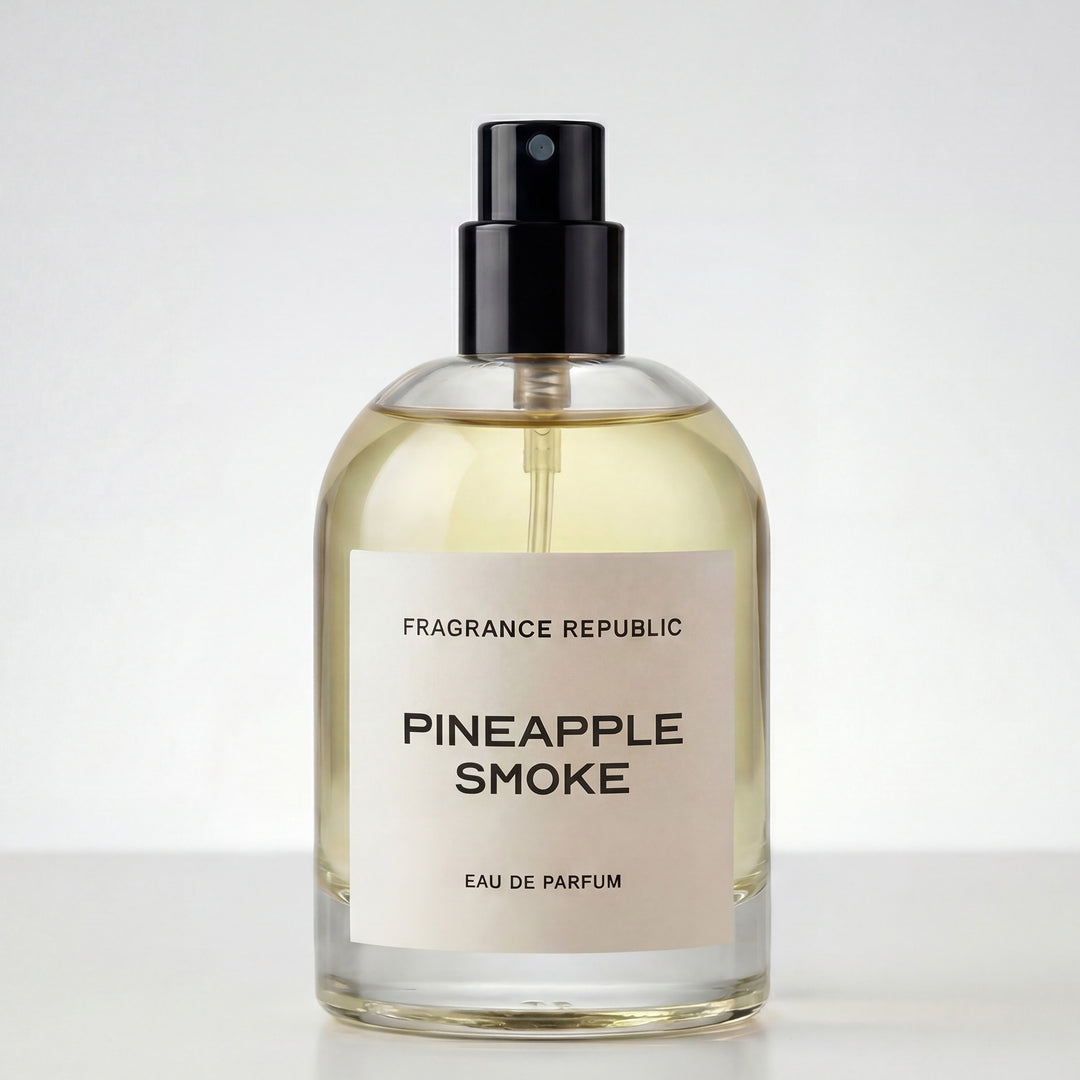 Clear glass bottle of Pineapple Smoke eau de parfum with black spray cap on white background