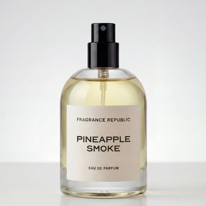 Clear glass bottle of Pineapple Smoke eau de parfum with black spray cap on white background
