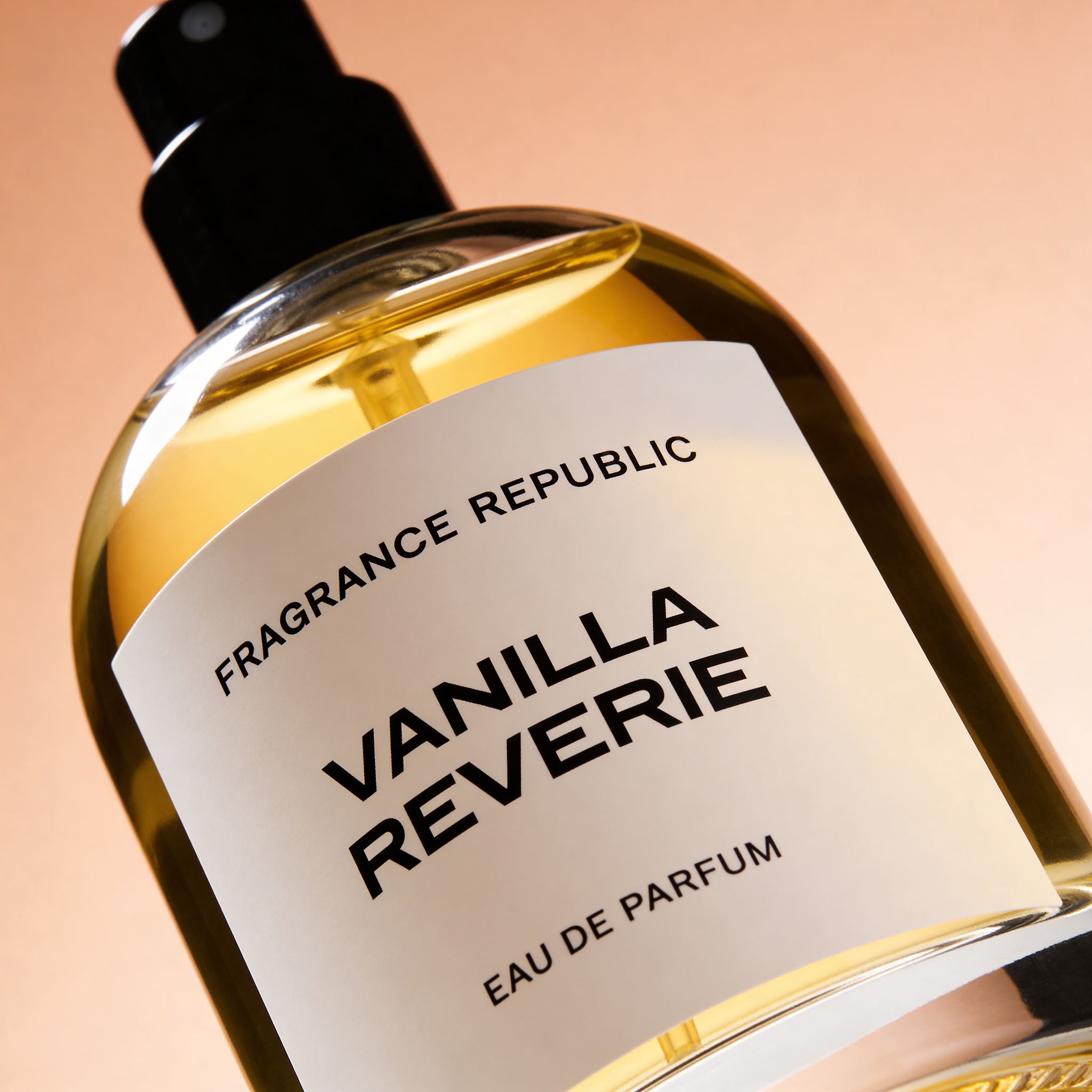 Close-up of Vanilla Reverie Eau de Parfum bottle with a sleek label and gold liquid