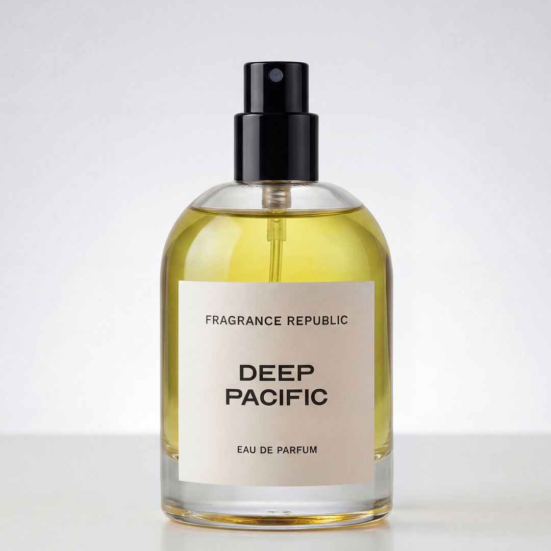 Clear glass spray bottle of Deep Pacific eau de parfum with yellow liquid and black cap