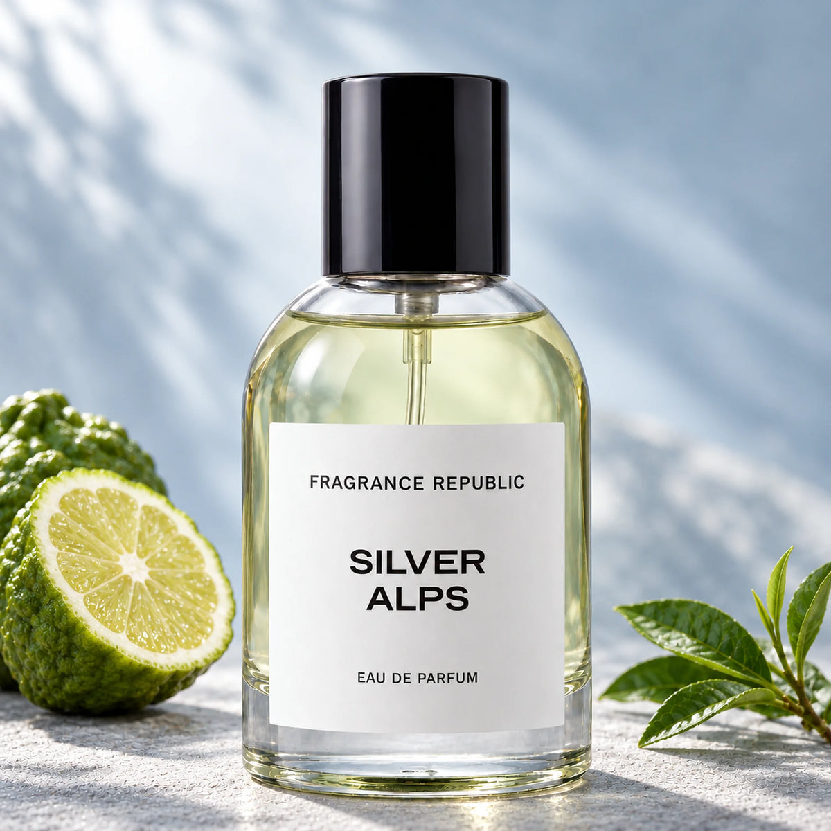 Fragrance Republic Silver Alps eau de parfum bottle beside a halved citrus fruit and green tea leaves.