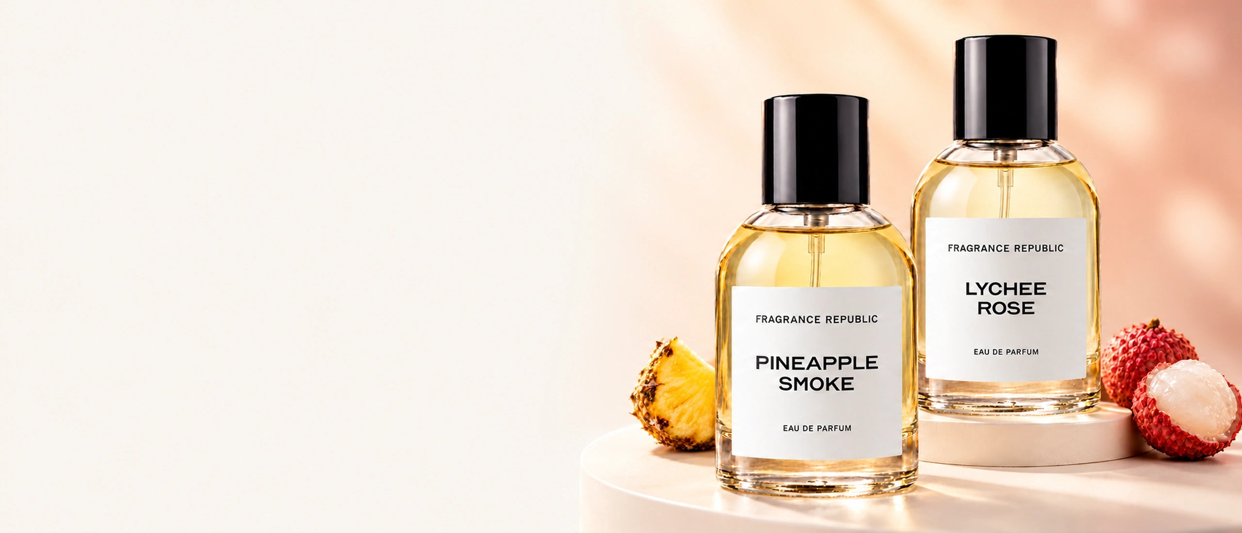 Pineapple Smoke and Lychee Rose perfumes in a clean ivory studio with pineapple and lychees.